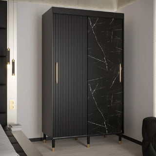 The CHOICEWARDROBE Millwall 120cm Black Marble Effect Wardrobe features 2 sliding doors—one with a ribbed panel, the other in black marble with white veining—finished with gold handles and gold-capped legs for a modern luxury look.