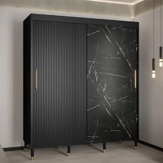 The CHOICEWARDROBE Millwall 180cm Black Marble Effect Wardrobe features two sliding doors—one with ribbed detailing, the other with a marble finish—plus gold handles, offering luxury modern bedroom storage and style.