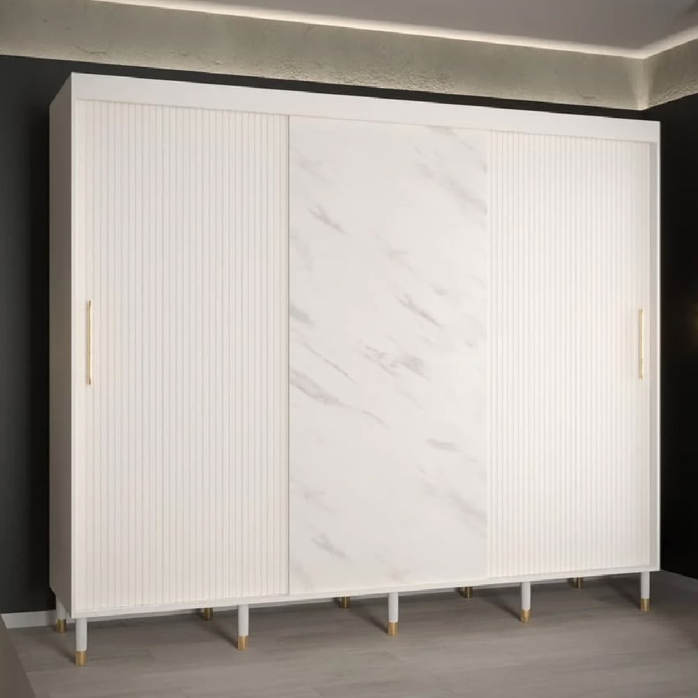 White marble effect sliding door wardrobe with ribbed panels and gold handles.