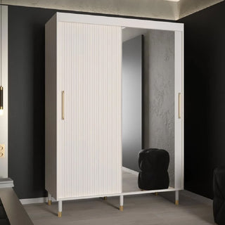 The CHOICEWARDROBE Millwall Mirrored Wardrobe (150cm) features 2 sliding doors in white with gold handles, a ribbed panel design, and a full-length mirror—modern premium storage perfect for compact bedrooms. A black cushioned stool is reflected in the mirror.