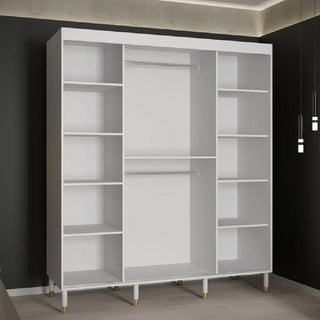 The CHOICEWARDROBE Millwall White Marble & Fluted Panel Sliding Wardrobe (180cm, 2 doors, gold handles) with ample storage stands against a dark wall in a modern room with light wood floors and pendant lighting.