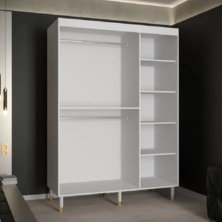 The CHOICEWARDROBE Millwall Wooden Sliding Door Wardrobe (150cm, white with gold handles and ribbed panels) stands in a modern room, offering stylish and practical bedroom storage.