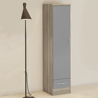 A tall, modern floor lamp with a cone-shaped shade stands next to the CHOICEWARDROBE Modara Grey & Light Oak 1 Door Wardrobe with Drawer, a 40 cm slim storage cabinet, against a light-colored wall.