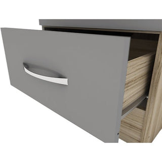 A close-up of the CHOICEWARDROBE Modara Grey & Light Oak 1 Door Wardrobe with Drawer (40 cm Slim Storage Cabinet) shows a partially open grey-fronted drawer with a silver handle, revealing its interior and smooth sliding mechanism.