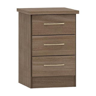 The CHOICEWARDROBE Modara Rustic Oak Bedside Table features a compact rectangular design, light brown finish, three drawers with metallic handles, flat top, and simple lines to match the full bedroom set.