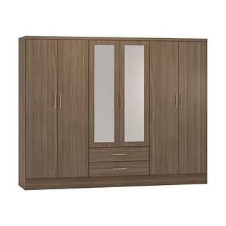 The CHOICEWARDROBE Modara Rustic Oak Effect Mirrored Wardrobe features 6 doors, 2 central drawers, gold-colored handles, and full-length mirrored doors, offering a complete storage suite in a stylish rustic oak finish.