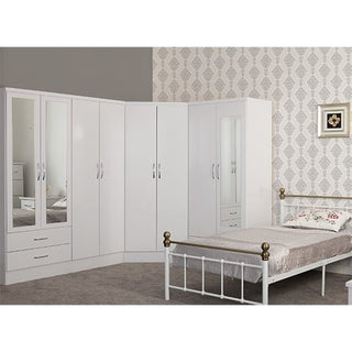Modara white gloss corner wardrobe displayed in a modern bedroom set with matching furniture, reflecting natural light for a spacious feel.