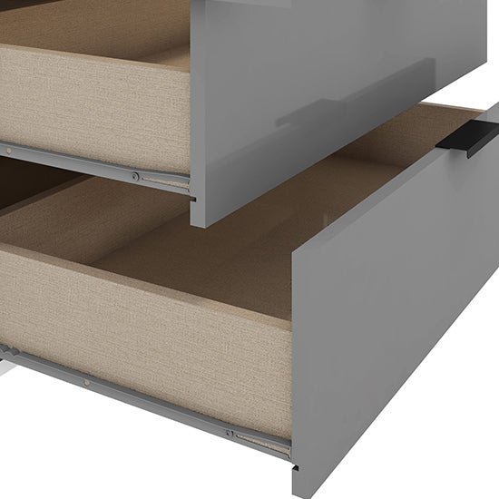 Grey gloss wardrobe drawers partially open, showing light fabric interior and metal runners