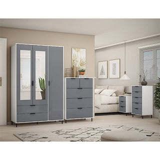 A modern living room features the CHOICEWARDROBE Nadric Grey & White Gloss 3 Door Mirrored Wardrobe with Drawers, complemented by gray and white furniture. A beige sofa, patterned rug, and artwork add style to the neutral-toned space.