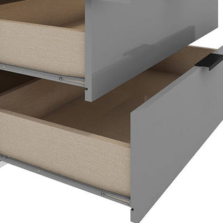 Two light wood drawers are partially open in the CHOICEWARDROBE Nadric Grey & White Gloss 4 Door Mirrored Wardrobe with Drawers, showcasing striking material contrast and contemporary metal legs from the side view.