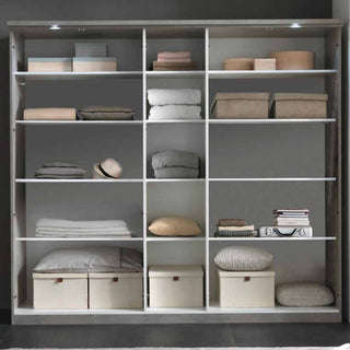 A white shelving unit with sixteen square compartments is neatly arranged with various items—pair it with the CHOICEWARDROBE Namilon 236cm 4 Door LED Mirrored Wardrobe in Concrete Grey & White Gloss for modern storage and style.