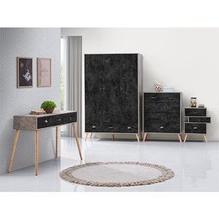 A modern bedroom set featuring the CHOICEWARDROBE Noein 113 cm 3 Door 3 Drawer Wardrobe in a concrete effect finish with wooden legs, paired with a chest of drawers, nightstand, and desk on a white floor with a round rug by the window.