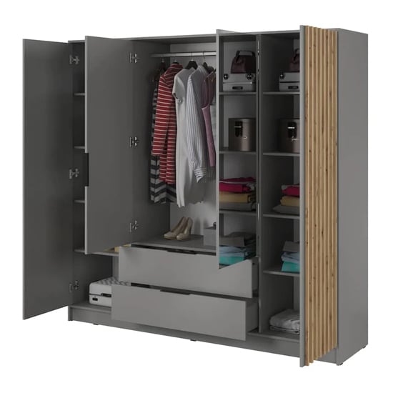 Grey 4-door wardrobe with oak slatted panels and central drawers, showing clothes and shelves.