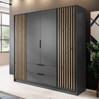 The CHOICEWARDROBE Norco 206cm 4 Door Wardrobe in matte black with oak slatted panels and central drawers stands against a brown wall in a well-lit room with light wood flooring and a potted plant nearby.