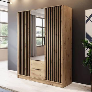 The CHOICEWARDROBE Norco 3 Door Mirrored Wardrobe (155cm, oak finish) with modern black slats, central mirror, drawers, and hanging rail stands against a gray wall in a bright, contemporary room.