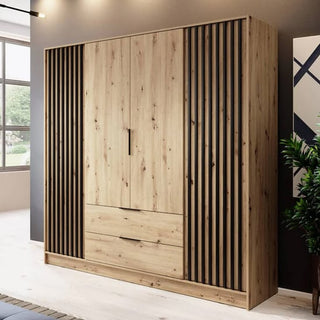 The CHOICEWARDROBE Norco 4 Door Wooden Wardrobe in oak and black features a modern slatted design, drawers, shelves, and a hanging rail for storage—perfect for well-lit rooms with plants and large windows.