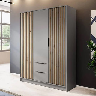 The CHOICEWARDROBE Norco Wooden Wardrobe features 3 grey hinged doors, vertical oak slat detailing, a central mirrored door, and two drawers below—offering ample modern storage in your bright bedroom.