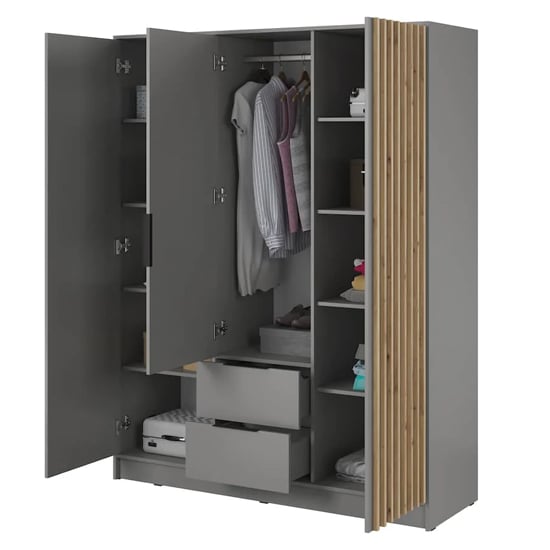 Grey 3-door wardrobe with oak slats, open interior showing hanging clothes, shelves, and drawers.