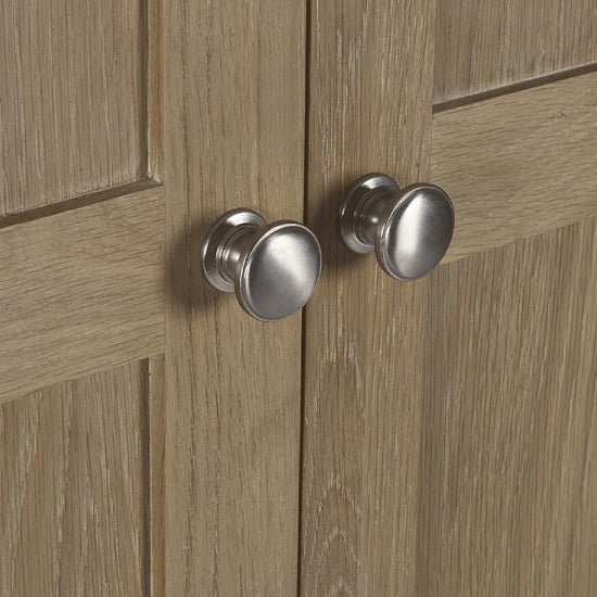 Brushed metallic round wardrobe handles on limed oak 2-door wardrobe doors, farmhouse style.