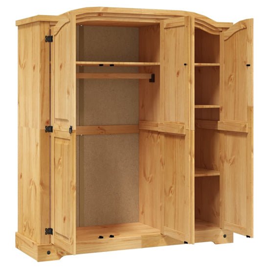 Open 3 door solid pine wardrobe showing hanging rail and shelves, rustic natural finish.
