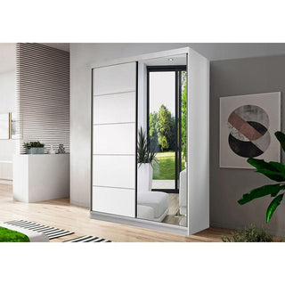The CHOICEWARDROBE Norvik 2 Door Sliding Wardrobe in a matt white finish (120cm) features a mirrored door. Shown in a bright room with wooden flooring, large window, and nearby wall art, it's ideal modern bedroom storage.