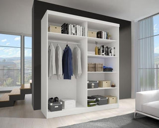 The CHOICEWARDROBE Norvik 2 Door Sliding Wardrobe in a matt white finish (120cm) features open shelves and a hanging rod, holding clothing and storage items. It adds modern bedroom storage to bright, minimally furnished rooms.