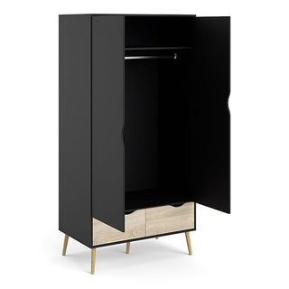 The CHOICEWARDROBE Nuvell Black & Oak 2 Door Wardrobe features a modern minimalist design with open doors, a hanging rail, two light wood drawers at the bottom, angled wooden legs, and a sleek black interior and sides.