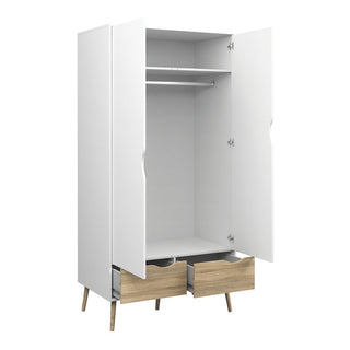 The CHOICEWARDROBE Okla 3 Piece Set in White & Oak features a 2 door wardrobe with hanging rail, shelf, and lower drawers on angled legs—ideal for Scandinavian minimalist bedroom style. Includes matching chest and bedside table.
