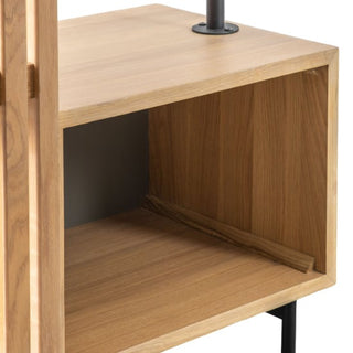 A close-up of the CHOICEWARDROBE Okonma Wooden Open Wardrobe in natural oak shows its slatted design, shelves, and black metal legs. The open square compartment and part of the vertical side panel are visible.