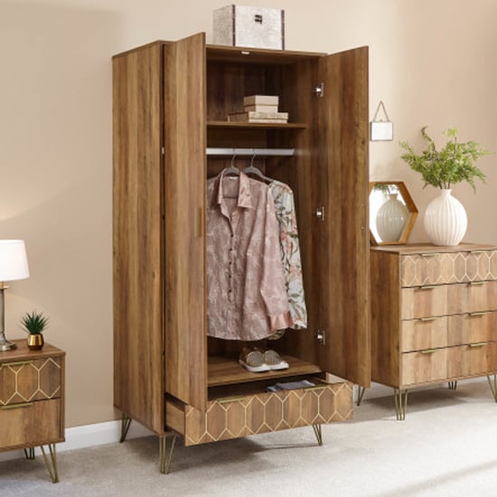 Orlana 2-door mango wood effect wardrobe with brass legs and geometric detailing.