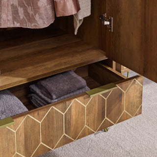 Close-up of Orleans wardrobe base drawer showing intricate gold geometric pattern and natural oak woodgrain texture.