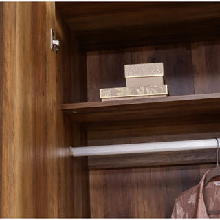 The CHOICEWARDROBE Orlana 2 Door Wardrobe in mango wood effect features a hanging rod, upper shelf, and two decorative boxes—ideal for modern bedroom storage with brass legs and geometric detailing.