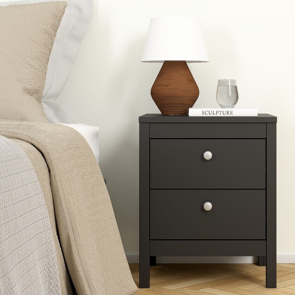 CHOICEWARDROBE Oslo black bedside table with lamp, water, and book, part of a bedroom set.