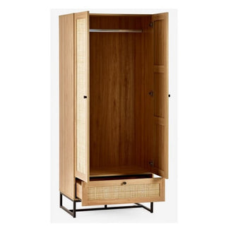 The CHOICEWARDROBE Pabla 2 Door 1 Drawer Wooden Wardrobe (80cm Oak Finish) features rattan-style front accents and a black metal frame base, blending retro and industrial styles for a chic statement piece.