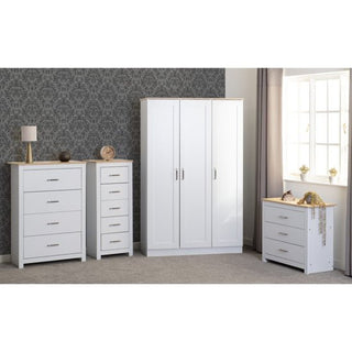 A bedroom set featuring the CHOICEWARDROBE Parnu White & Oak Wooden 3 Door Wardrobe, two white dressers in different sizes, and a matching bedside table, all set against gray patterned wallpaper and cream curtains.