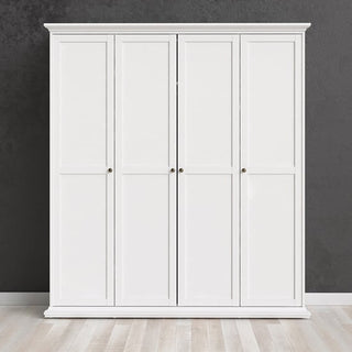 The CHOICEWARDROBE Paroya 4 Door Wardrobe in classic white wooden finish stands against a dark gray wall on a light wooden floor, offering elegant bedroom storage with ample hanging and shelf space (200cm width).