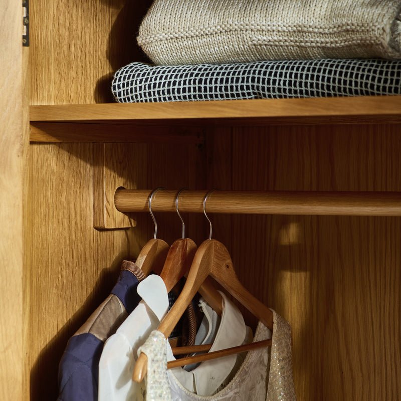 CHOICEWARDROBE Porsha 142cm waxed oak wardrobe interior with shelves and hanging rail.