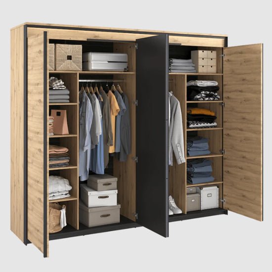 Rustic oak 4 door hinged wardrobe interior showing shelves, hanging clothes, and storage baskets.