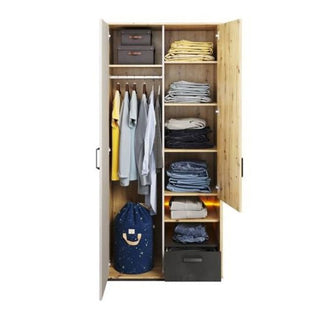 The CHOICEWARDROBE Quincy 2 Door Kids Wardrobe in oak & grey features LED lighting, hanging space on the left, shelves with folded clothes and child-friendly storage boxes on the right, plus a blue laundry bag and dark box at the bottom.