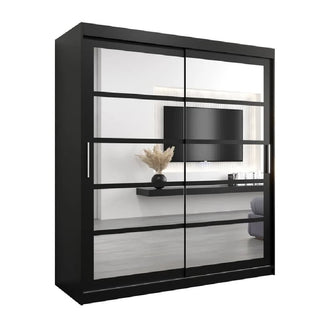 The CHOICEWARDROBE Reston Sliding Mirror Wardrobe, 2 doors, 180cm wide in black, reflects a modern living room with a wall-mounted TV, floating shelf, vase with dried plants, and part of a gray sofa.