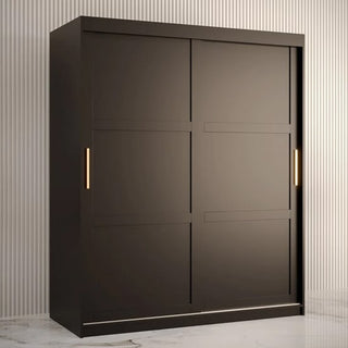 The CHOICEWARDROBE Rieti 2 Door Sliding Wardrobe (150cm, Matt Black) with gold handles and internal shelves stands out against a light, striped wall on white marble flooring—an elegant piece for modern bedroom decor.