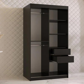 The CHOICEWARDROBE Rieti I 2 Door Sliding Wooden Wardrobe in a black finish stands on a white marble floor against a quilted pattern wall—100cm wide, with gold handles and internal storage shelves for stylish modern bedroom organization.