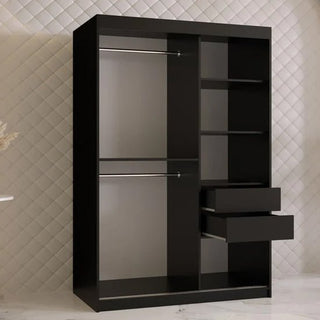 The CHOICEWARDROBE Rieti I 120cm black wooden wardrobe with modern gold handles, soft-close sliding doors, and spacious shelving stands on a white marble floor against a quilted-pattern wall.