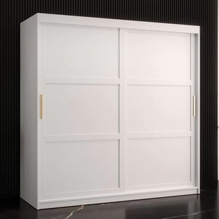 The CHOICEWARDROBE Rieti I Wooden Wardrobe—180cm, white with 2 sliding doors, gold handles, and adjustable shelves—adds sleek modern storage to a bedroom with a dark grooved wall and black floor.