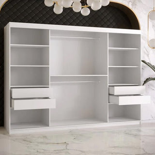 Open drawers and storage compartments of Rieti wardrobe highlighting white matte finish and smooth handleless design.