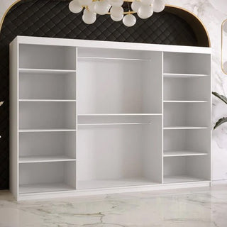 Interior of Rieti white wardrobe showing symmetrical shelves, hanging rails, and ample storage capacity.