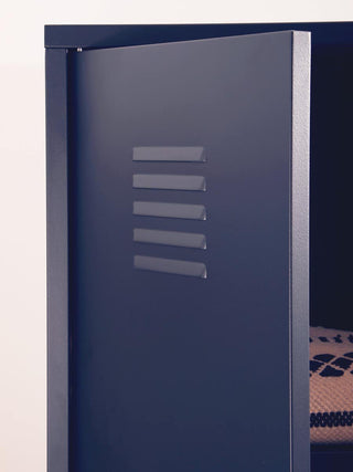 A close-up of the CHOICEWARDROBE Ruston Black Metal Locker Wardrobe (2 Door) with shelves and hanging rail shows horizontal ventilation slits and a peek of a patterned item inside this modern industrial storage cabinet.