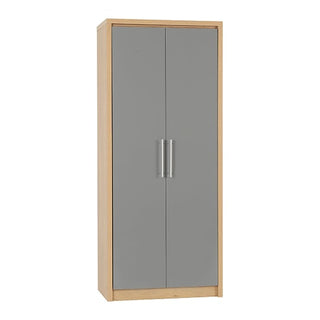 The CHOICEWARDROBE Samaira Grey Gloss 2 Door Wardrobe features a slim modern design with an oak effect frame, two plain grey doors with vertical silver handles, hanging rail, shelf storage, and stands on a flat base.