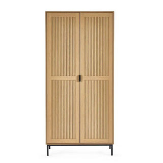 The CHOICEWARDROBE Sarnia Natural Oak 2 Door Wardrobe features slatted wood doors, black metal legs, and a Japandi modern design. Its natural oak finish and streamlined form bring a simple, elegant touch to any space.