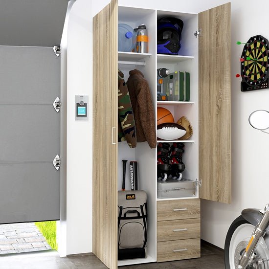 CHOICEWARDROBE Scalia 2 door oak wardrobe open, storing sports gear, helmet, jacket, backpack, and drawers.